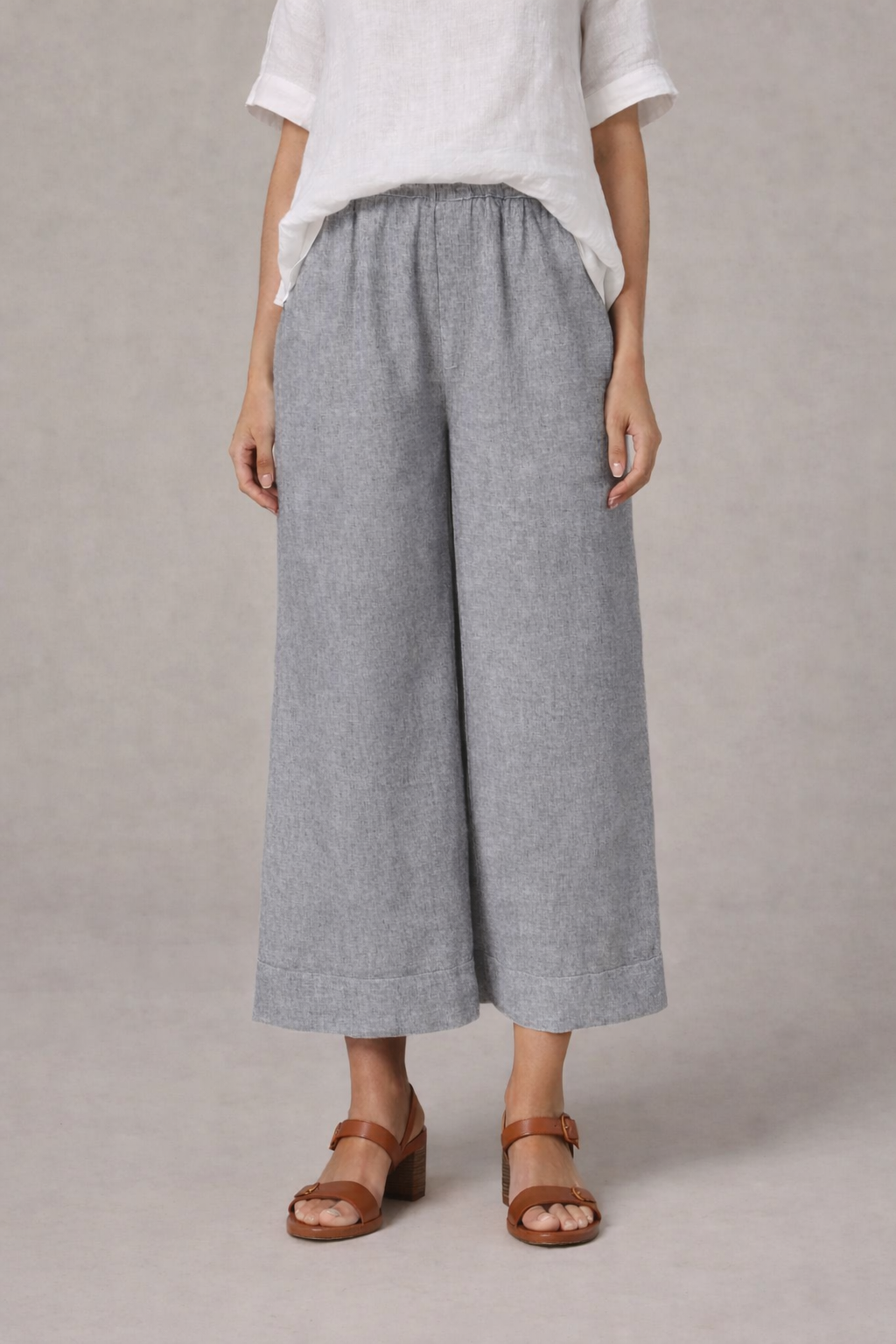Woman wearing wide leg cropped linen pants in grey