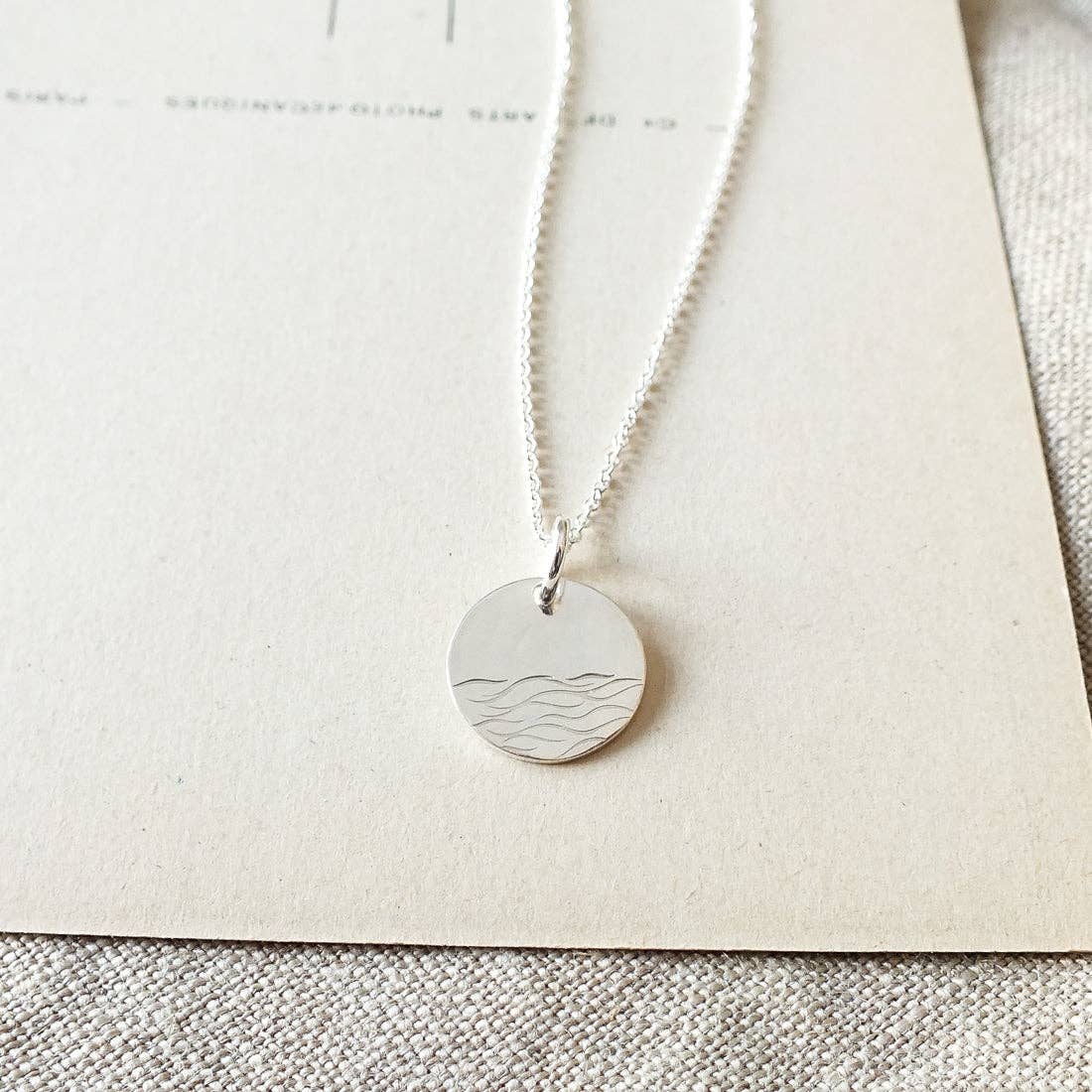 The Sea sterling silver charm necklace with waves detail by Becoming Jewelry made in USA with quote card