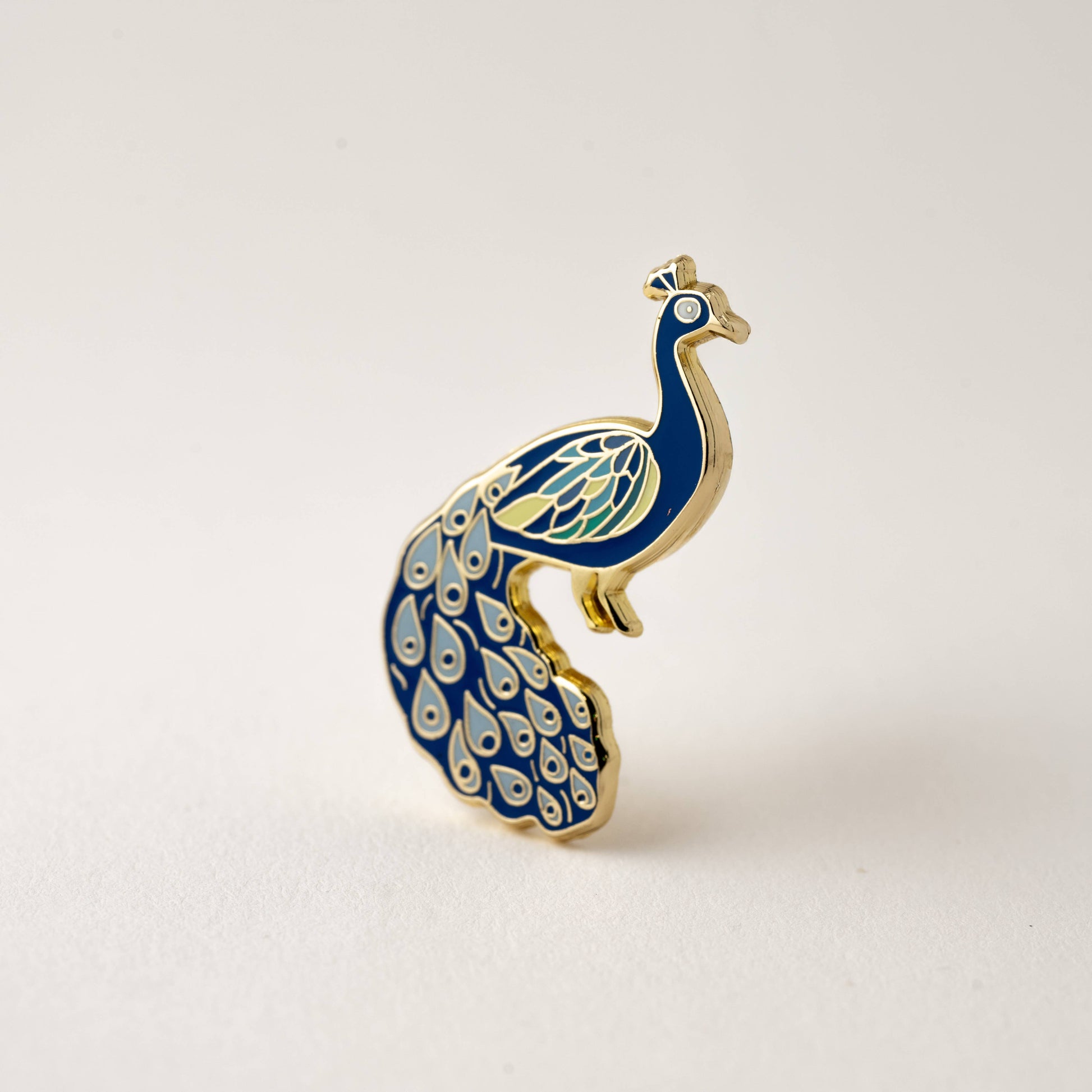 Happily Plants blue and gold peacock enamel pin
