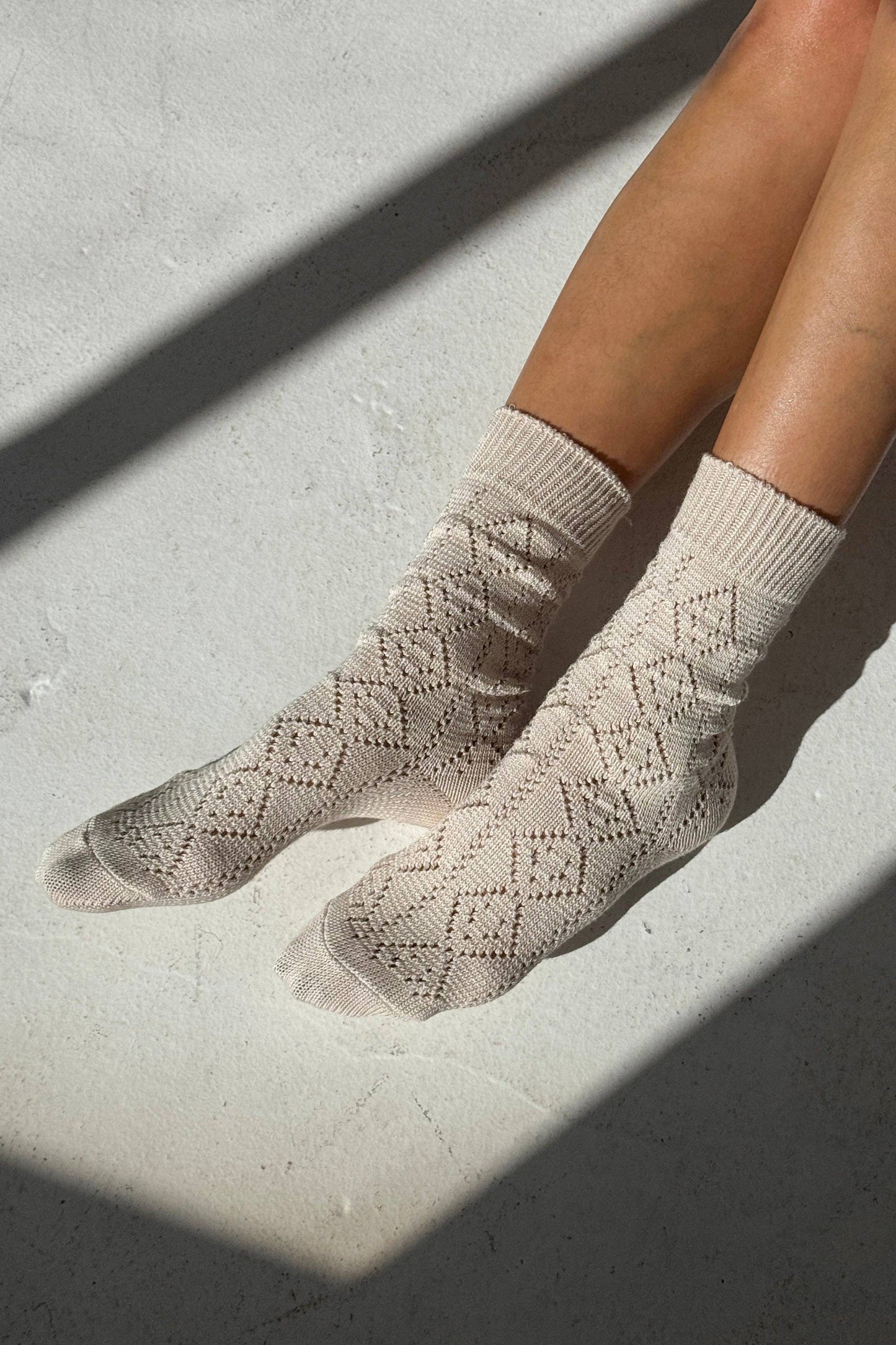 Woman wearing Le Bon Shoppe socks - ivory with pointelle knit