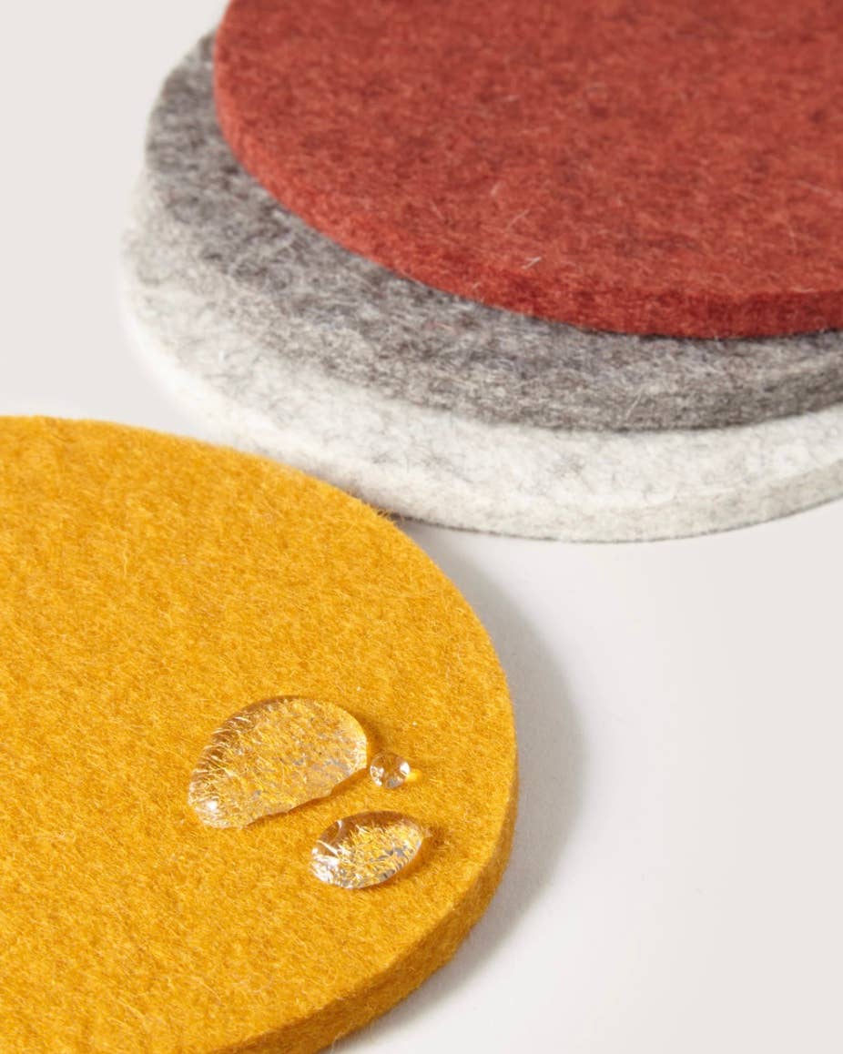A set of Graf Lantz coasters in rad 70s inspired shades of rust, mustard, and greys.