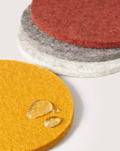 A set of Graf Lantz coasters in rad 70s inspired shades of rust, mustard, and greys.