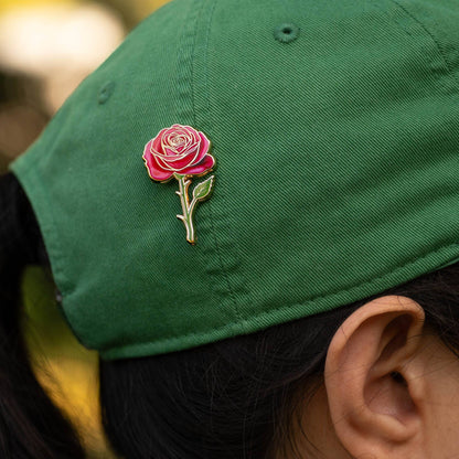rose enamel pin on green cap