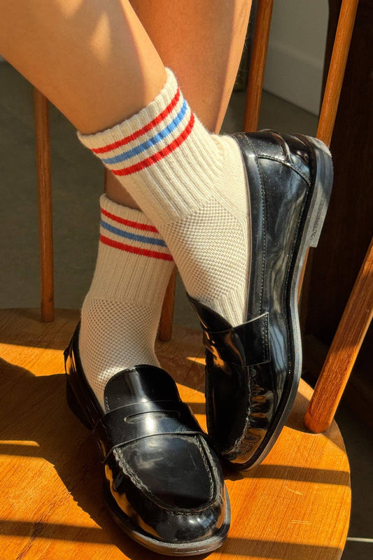 Woman wearing Le Bon Shoppe womens quarter crew socks leche with red white and blue stripes