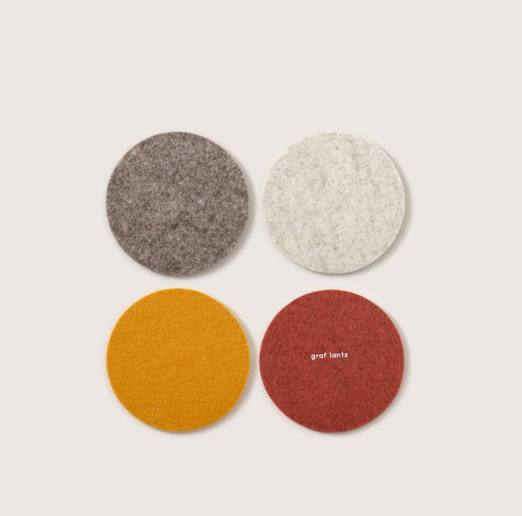 A set of Graf Lantz coasters in rad 70s inspired shades of rust, mustard, and greys.