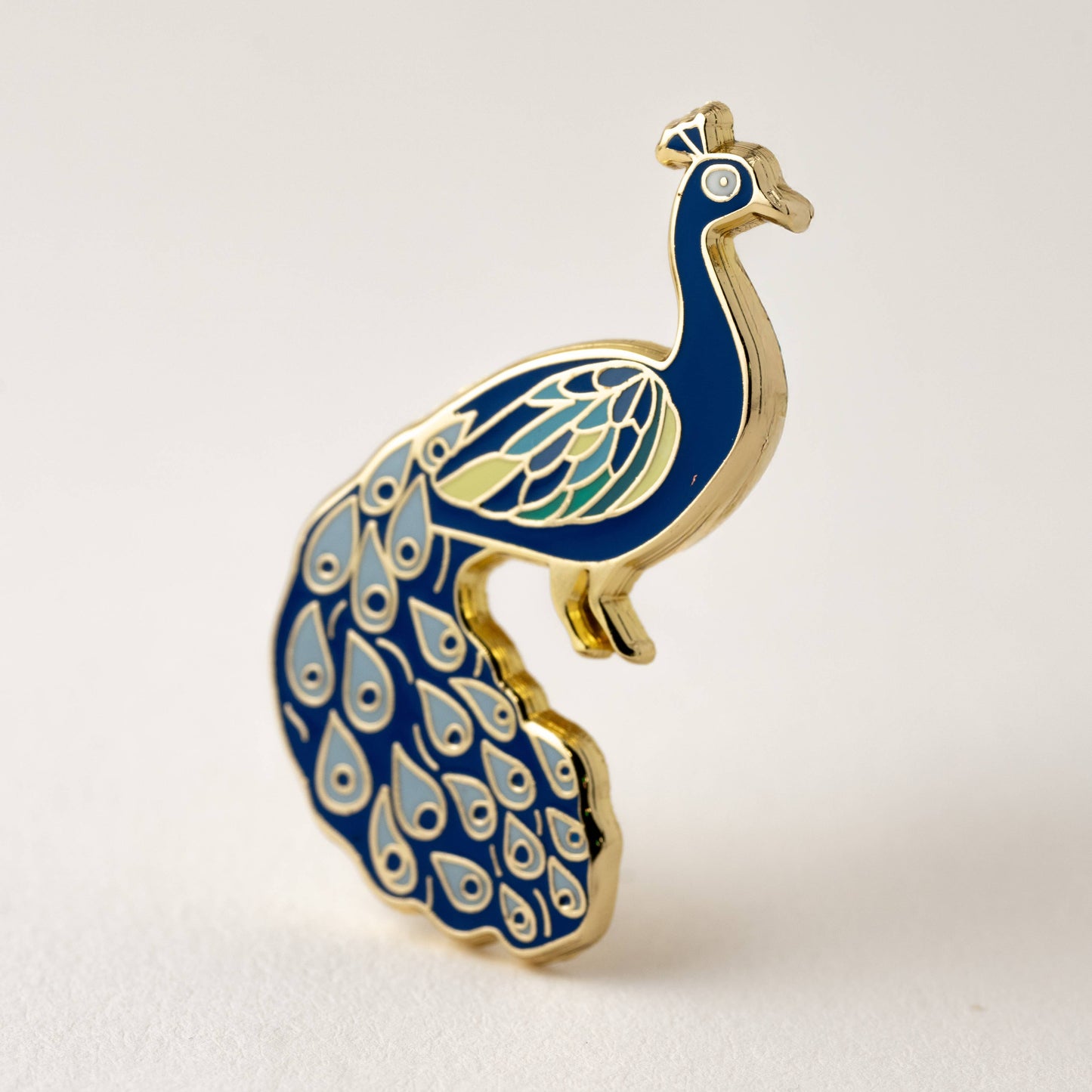 Happily Plants blue and gold peacock enamel pin