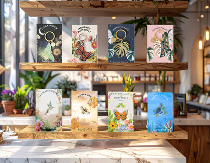 Collection of nature themed keychains and enamel pins by Happily Plants