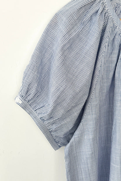 Close up of blue and white striped puff sleeve blouse by le bon shoppe