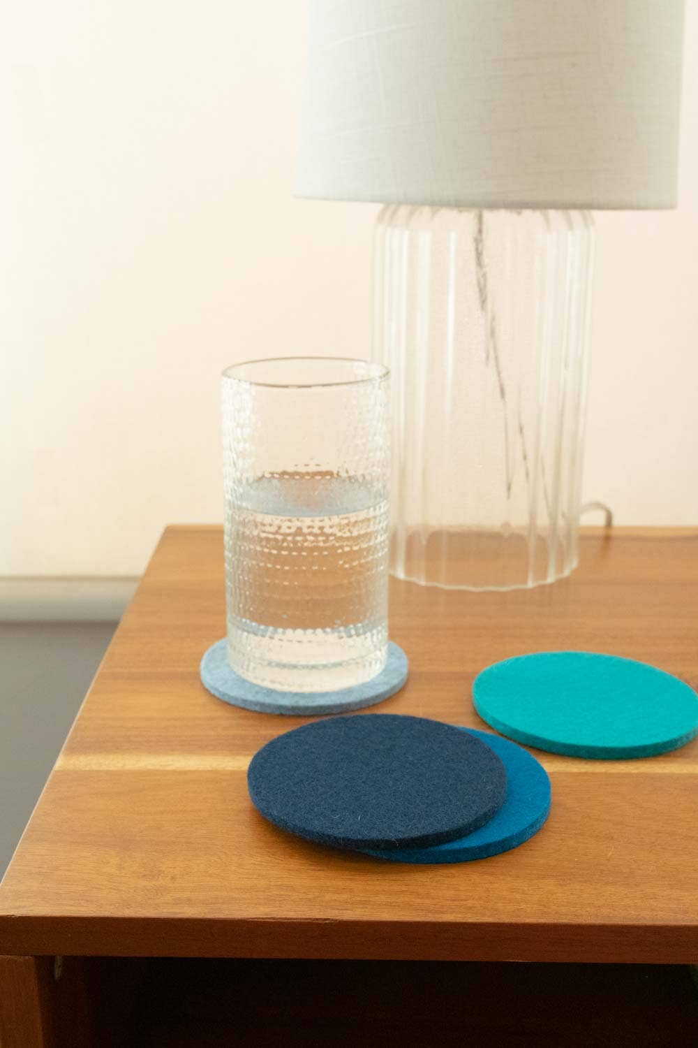 Set of blue coasters on a wooden table from Graf Lantz
