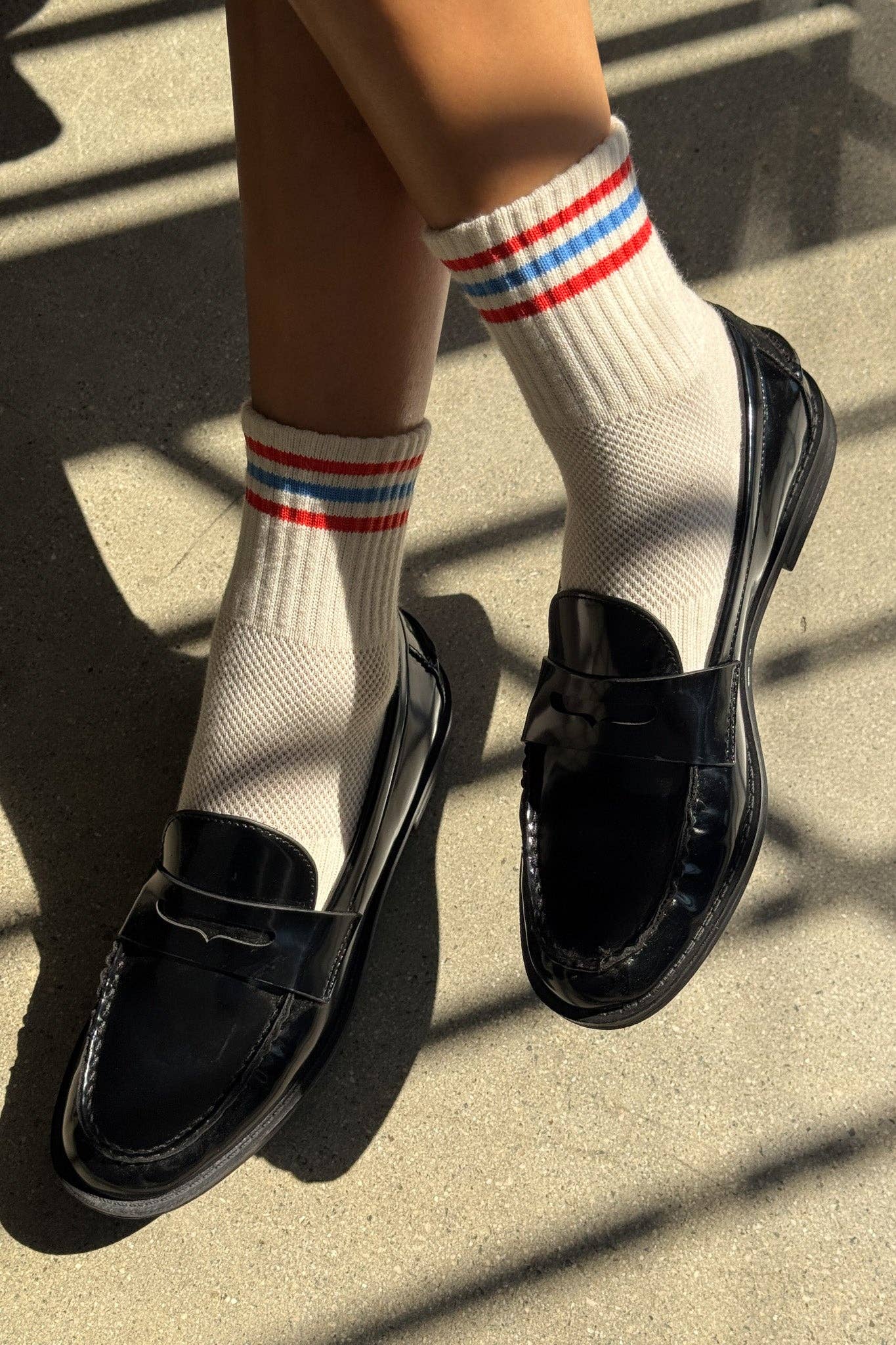 Woman wearing loafers with Le Bon Shoppe womens quarter crew socks leche with red white and blue stripes